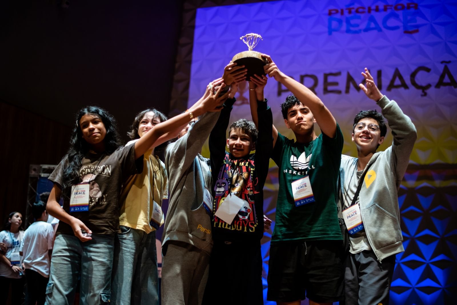 An award-winning group raising the trophy on the Pitch for Peace stage